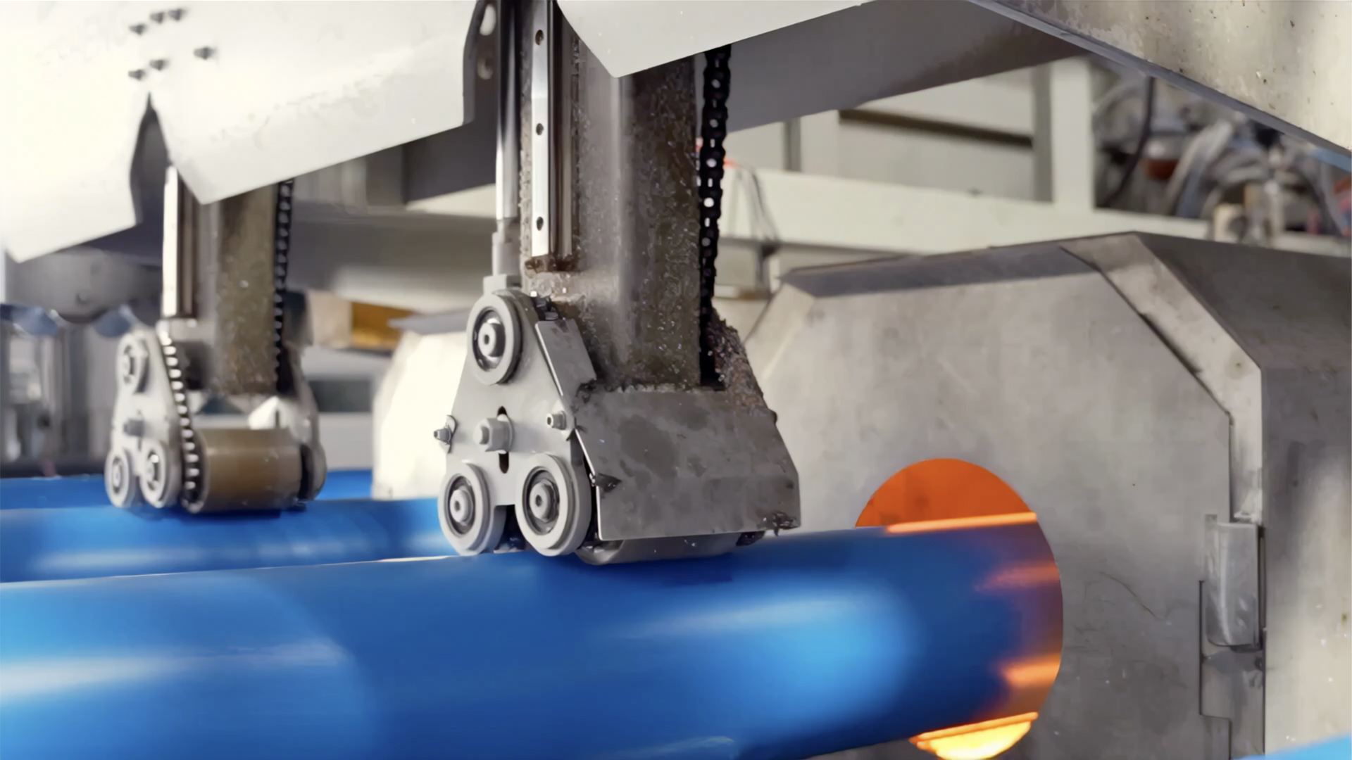 Blue UPVC pipe emerging hot from the extrusion die at Al Hilal Plastic factory, Al Hilal Industrial Group